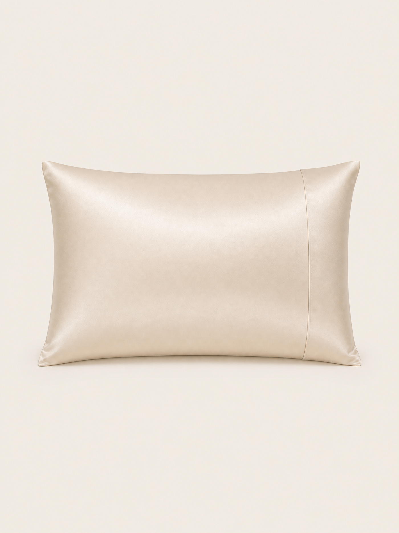 The NOLL silk pillowcase in warm ivory, shown straight on against a bone background