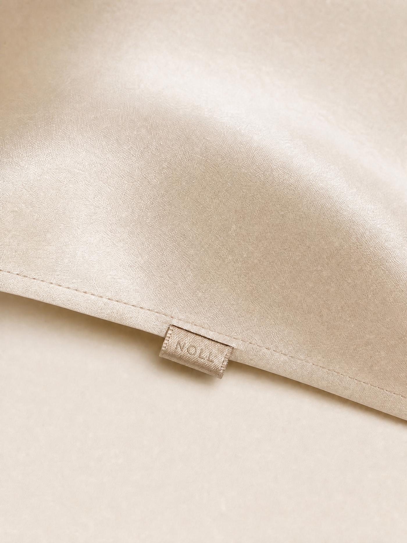 Close-up of the hemmed seam and the small woven NOLL label