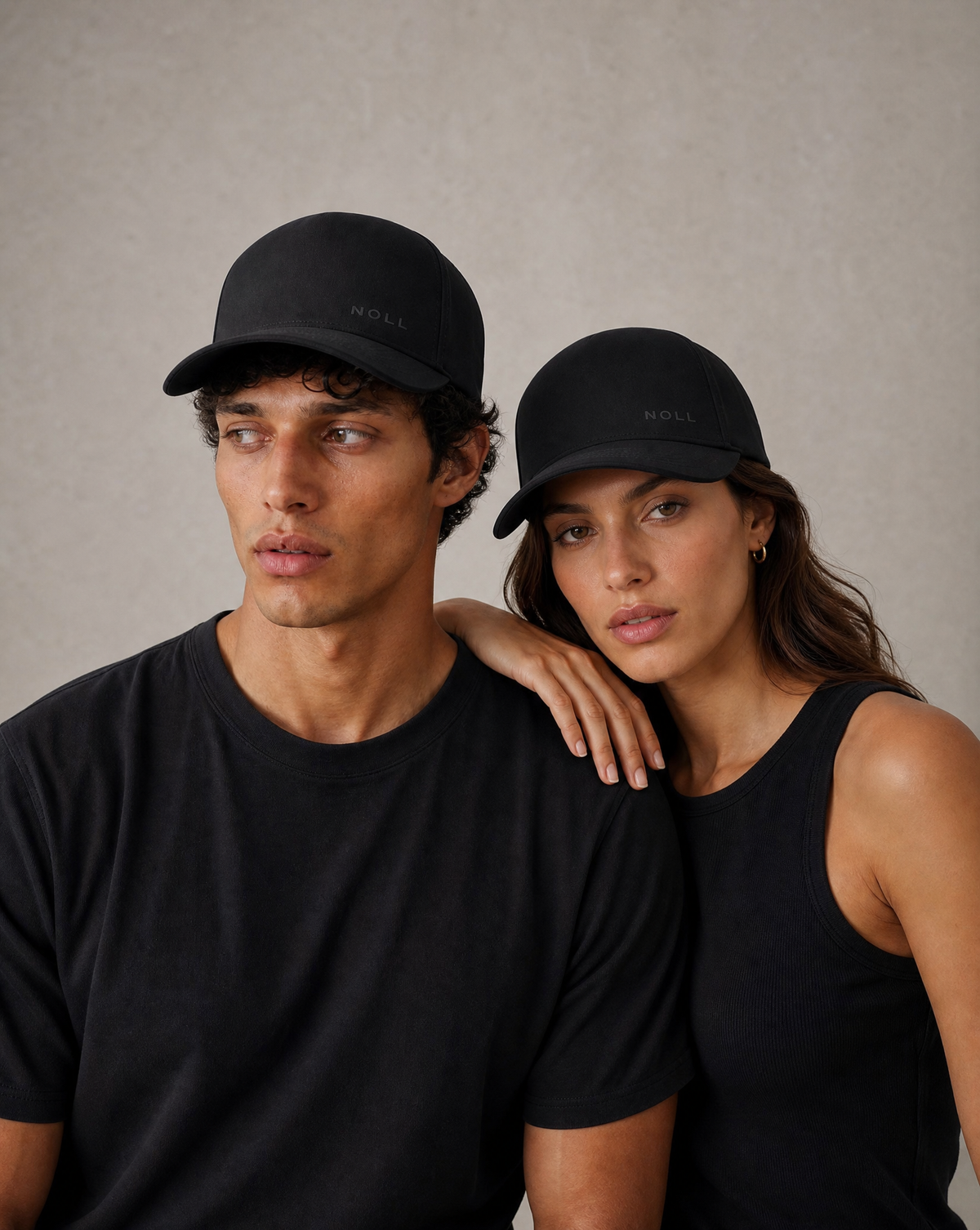 A man and a woman wearing the NOLL 01 hat in matte black