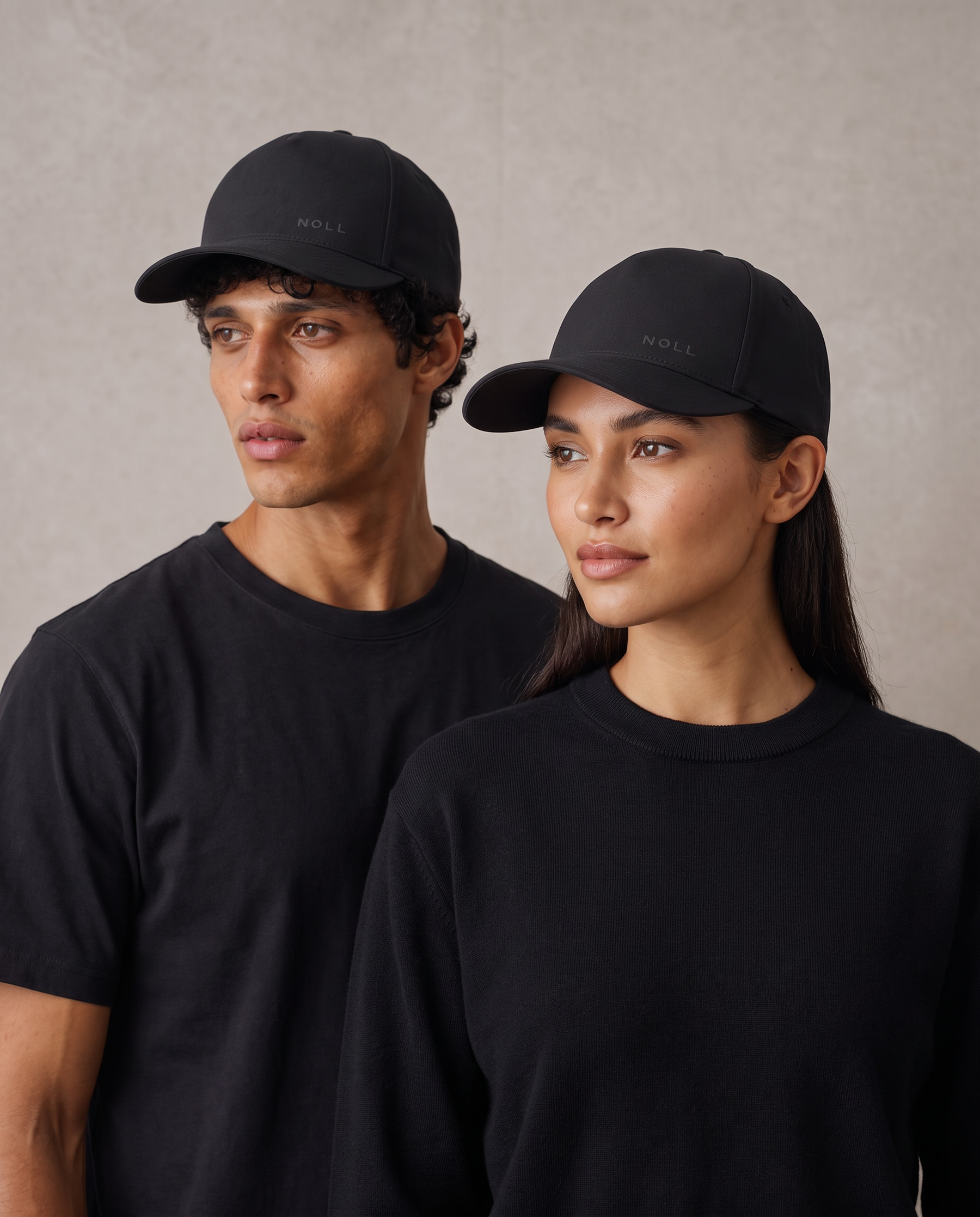 Two people wearing the NOLL 01 hat in matte black