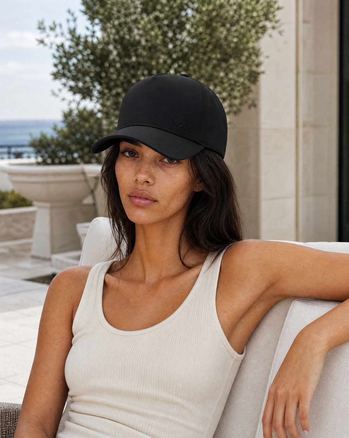 Matte Black woman wearing the NOLL 01 hat