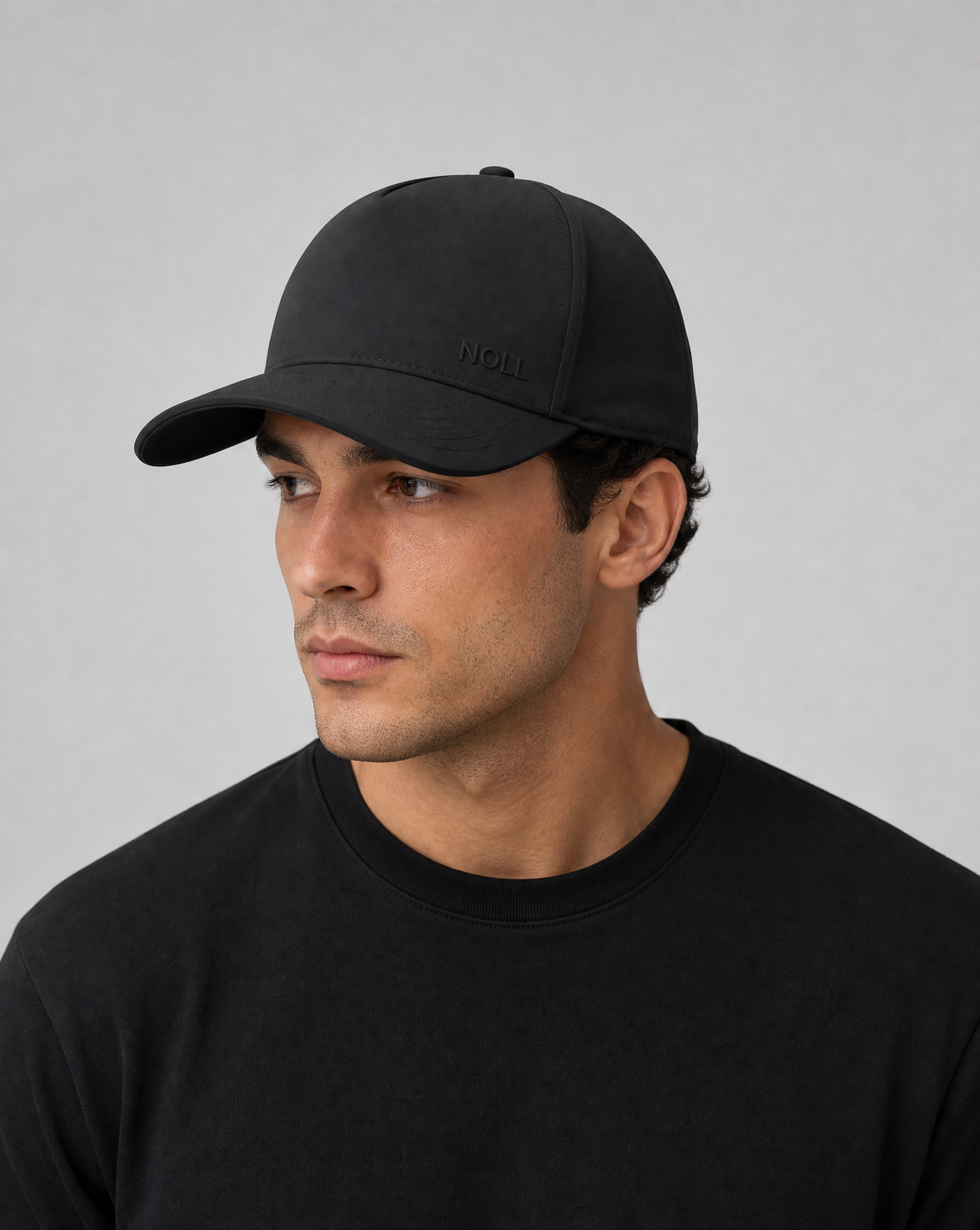 A man wearing the NOLL 01 silk-lined cap in matte black